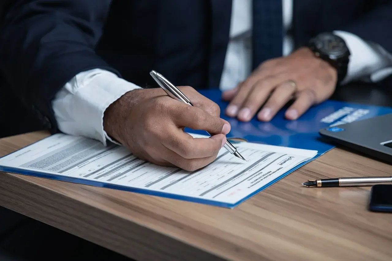 Businessman signing official documents for attestation services in Bangladesh for visa and immigration.