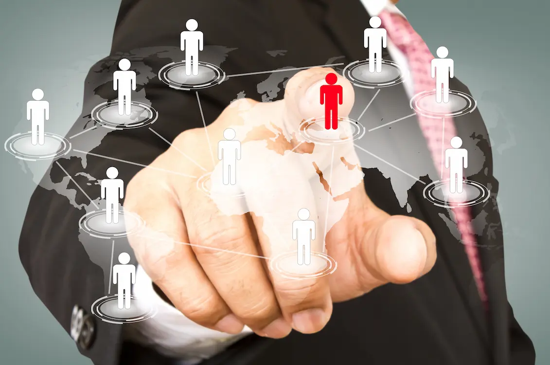 PEO Bangladesh – Businessman selecting an employee icon on a virtual global network map, representing services by a Professional Employer Organization.