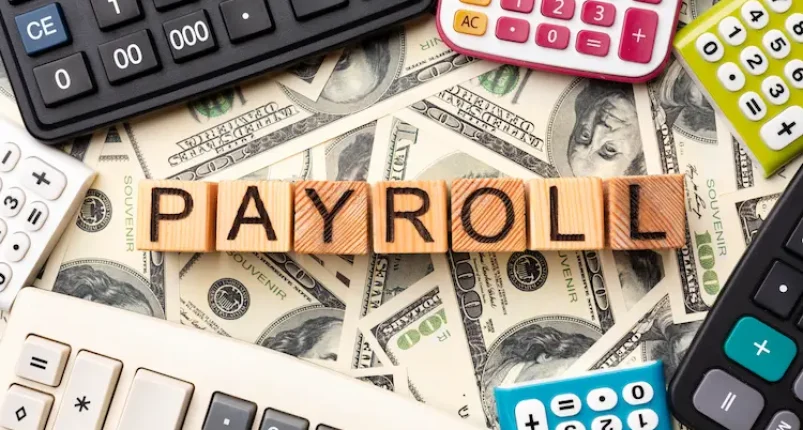 Payroll tax in Bangladesh with calculators and dollar bills – Bangladesh Consultant